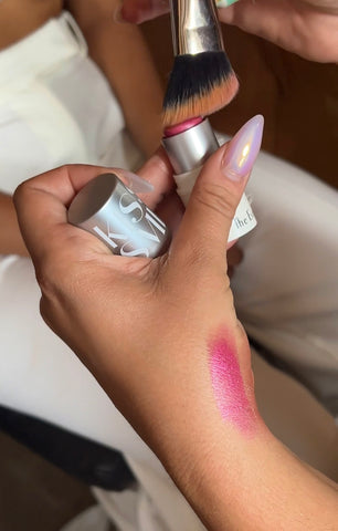 delta makeup artist playing with brush and makeup cream blush kiss and smink